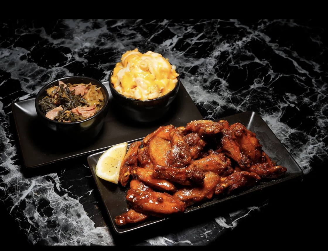 Glazed wings served with macaroni and cheese and greens